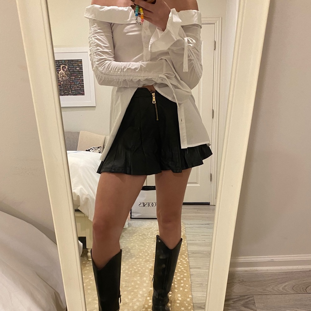 Black leather shorts with gold zipper